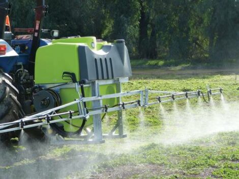 TTI Linkage Boom Spray on back of tractor chemical spraying from boom onto field in Australia